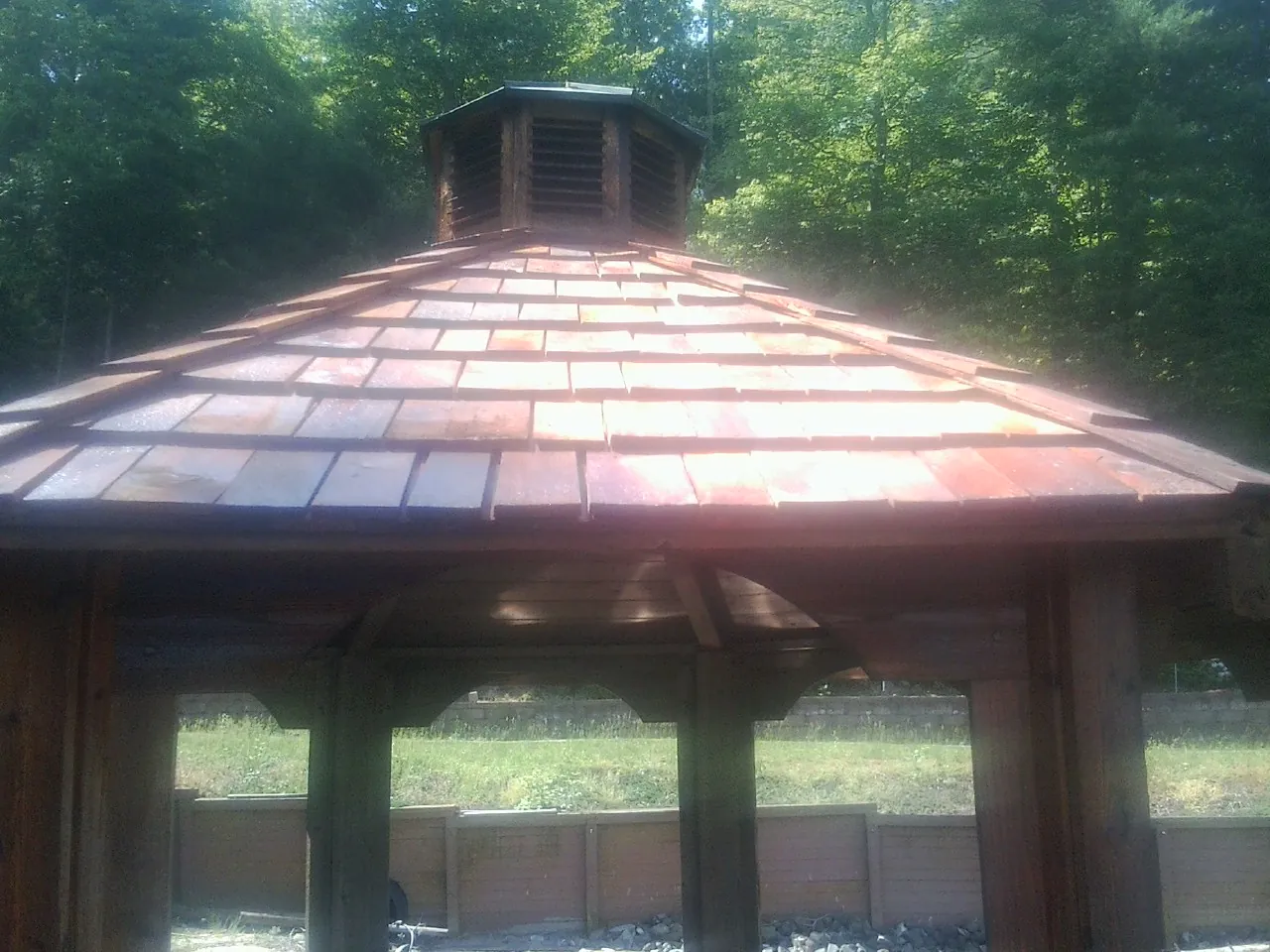 New cedar shake roof and cupola on a lakeside gazebo in Saint Charles